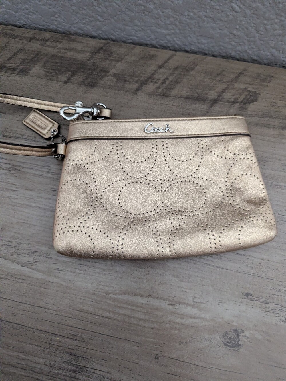 COACH Metallic Gold Perforated Signature C Wristlet